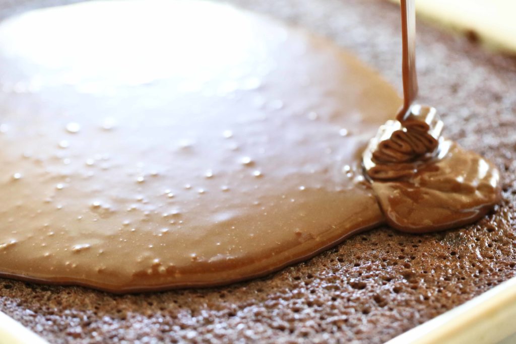 Pouring frosting on Texas Sheet Cake