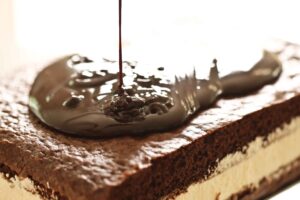 Homemade chocolate cake with cream filling and chocolate ganache
